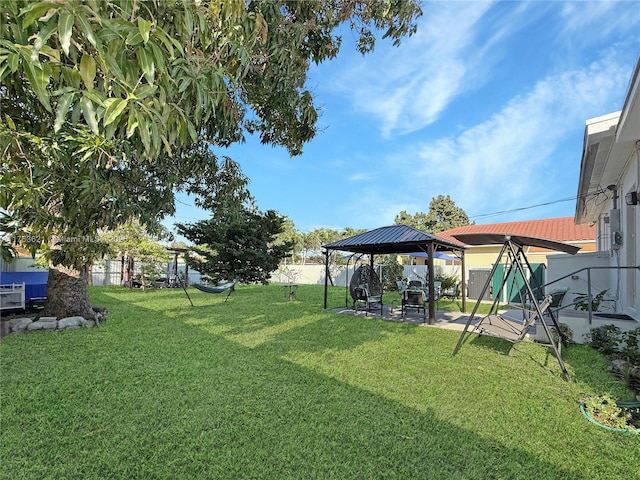 view of yard featuring a gazebo, fence, and a patio area