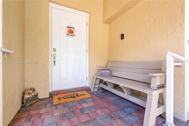 property entrance featuring stucco siding