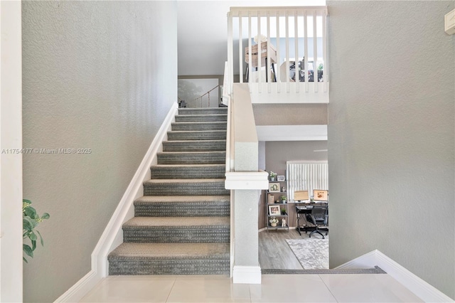 stairs featuring a textured wall