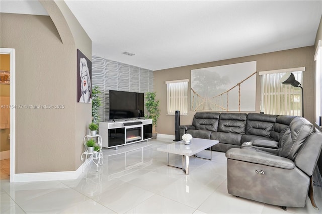 7546 NW 18th Dr, Pembroke Pines, FL 33024 - living room with visible vents, an accent wall, tile patterned flooring, baseboards, and wallpapered walls
