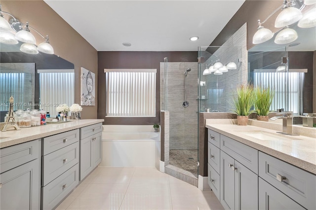 full bath with a shower stall, two vanities, a bath, tile patterned floors, and a sink