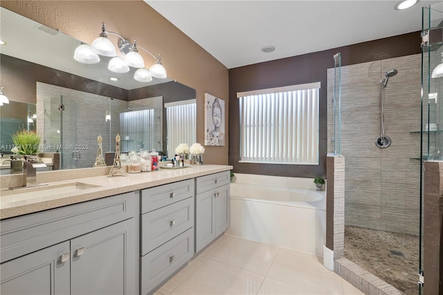 bathroom featuring tile patterned floors, a stall shower, a sink, double vanity, and a bath