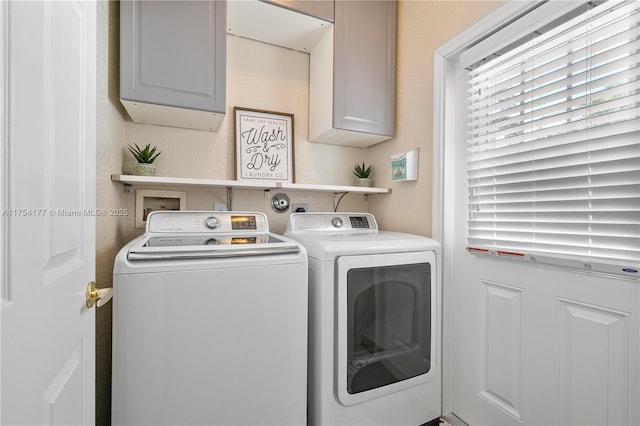 washroom with cabinet space and independent washer and dryer