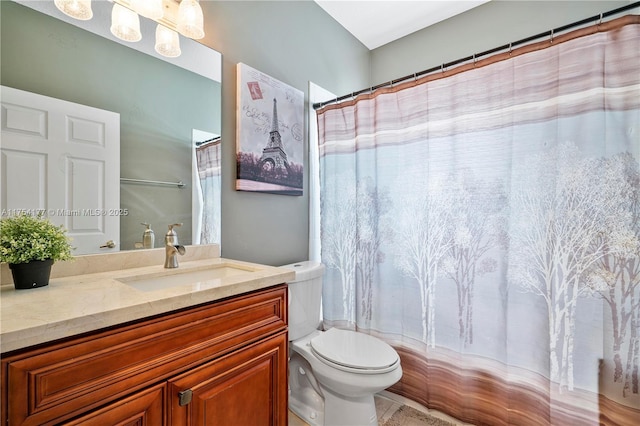 bathroom with toilet, vanity, and a shower with curtain