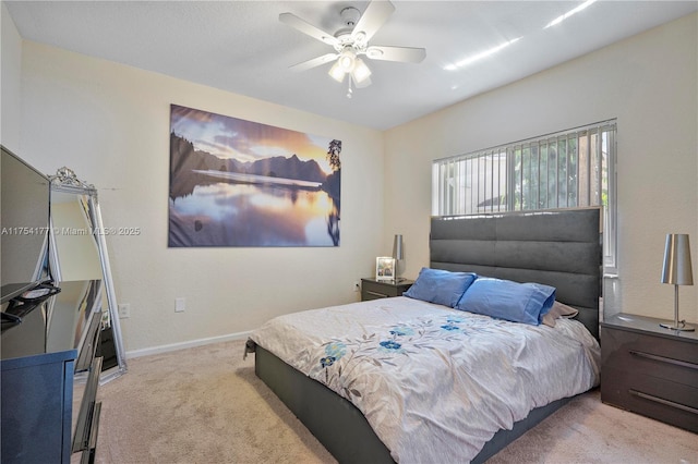 carpeted bedroom featuring baseboards and a ceiling fan