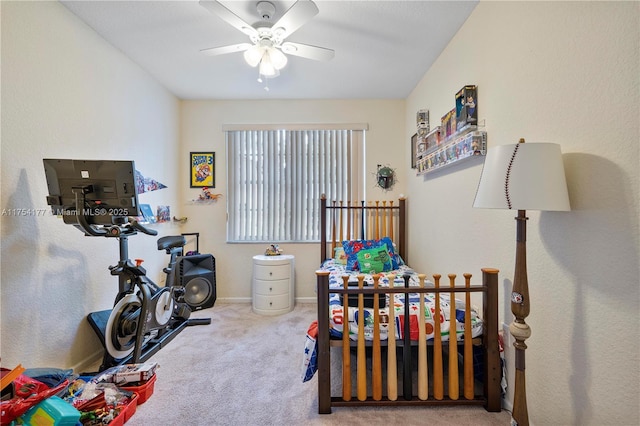 bedroom featuring ceiling fan and carpet