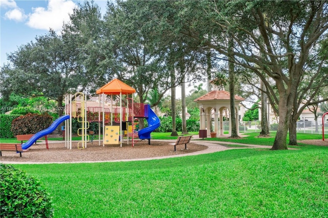 community jungle gym with a yard