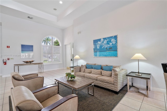 living area with visible vents, baseboards, recessed lighting, tile patterned flooring, and a raised ceiling