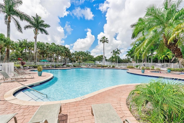 community pool featuring a patio area and fence