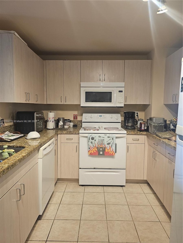 kitchen featuring white appliances, light tile patterned flooring, and light brown cabinets