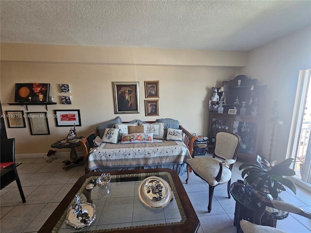 living area featuring tile patterned flooring and a textured ceiling