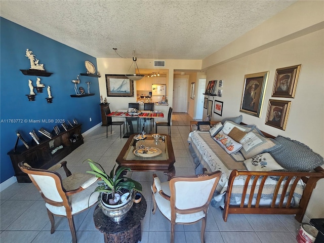 tiled living area featuring visible vents, baseboards, and a textured ceiling