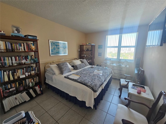 bedroom with tile patterned floors and a textured ceiling