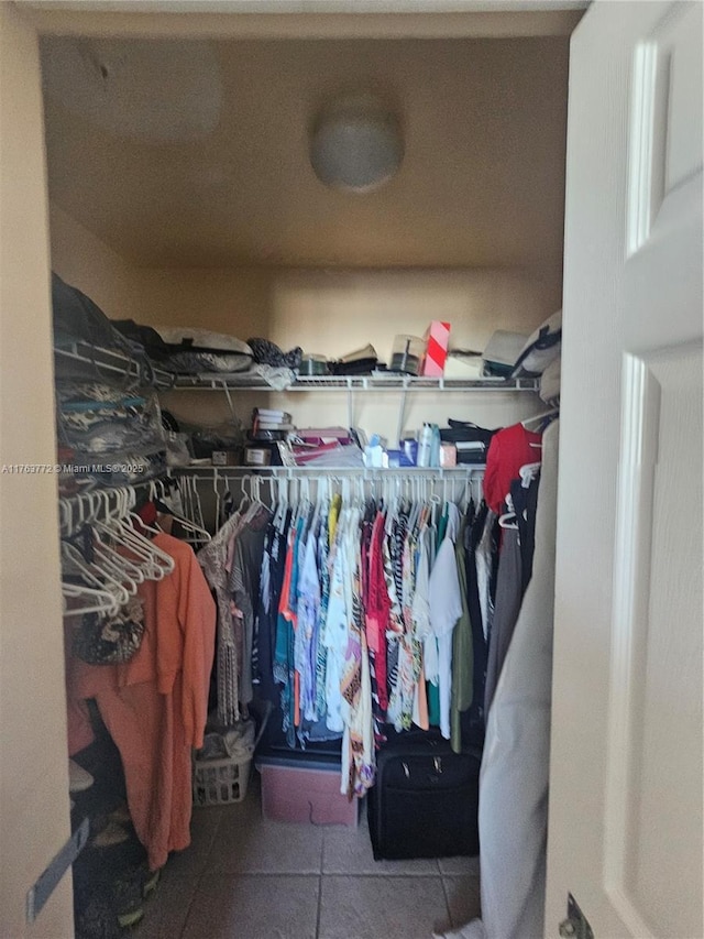 spacious closet featuring tile patterned flooring