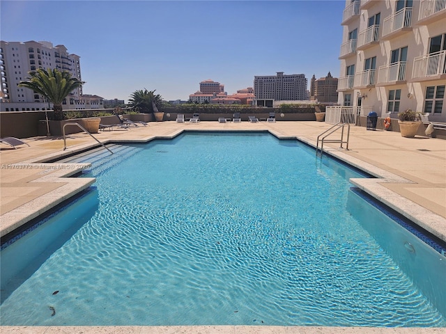 pool with a city view and a patio