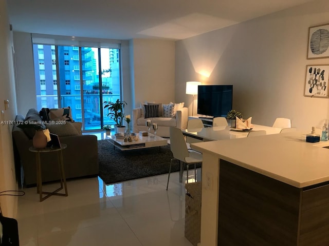 living room with tile patterned flooring and floor to ceiling windows