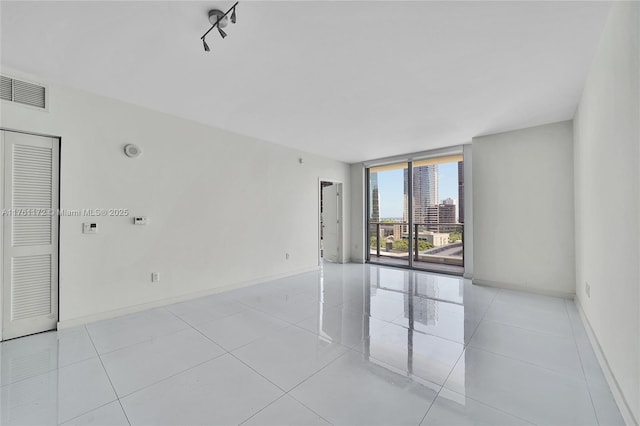 1100 S Miami Ave Unit 1103, Miami, FL 33130 - unfurnished room with a wall of windows and light tile patterned floors