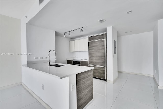 1100 S Miami Ave Unit 1103, Miami, FL 33130 - kitchen featuring built in fridge, modern cabinets, a peninsula, rail lighting, and light countertops