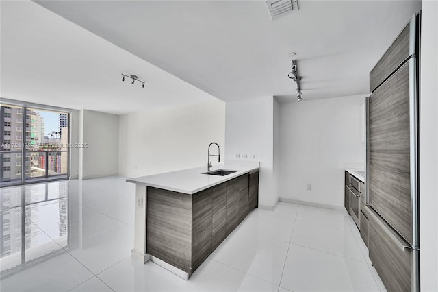 1100 S Miami Ave Unit 1103, Miami, FL 33130 - kitchen featuring modern cabinets, rail lighting, high end fridge, light countertops, and floor to ceiling windows