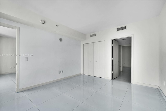 1100 S Miami Ave Unit 1103, Miami, FL 33130 - unfurnished bedroom featuring a closet and light tile patterned flooring