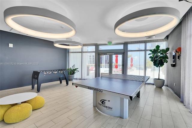 1100 S Miami Ave Unit 1103, Miami, FL 33130 - playroom with a wall of windows, healthy amount of natural light, french doors, light wood finished floors, and a raised ceiling