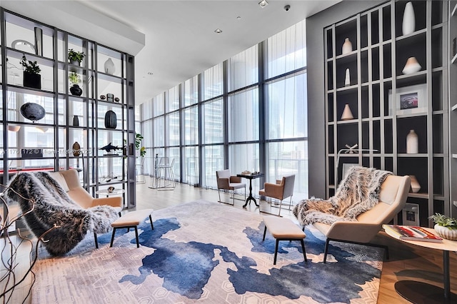 1100 S Miami Ave Unit 1103, Miami, FL 33130 - sitting room featuring a wall of windows, wood finished floors, plenty of natural light, and a towering ceiling
