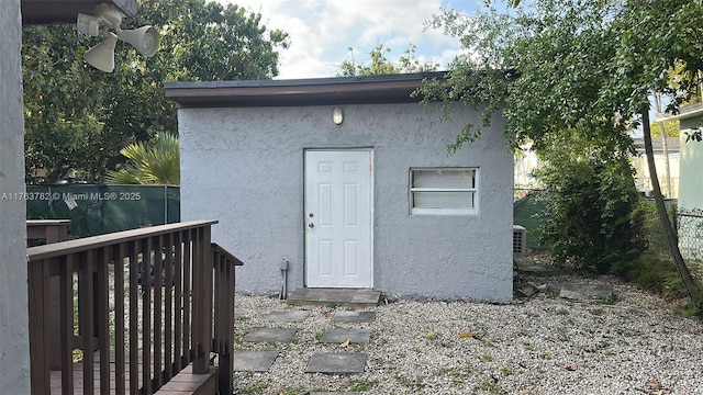 view of outbuilding featuring fence