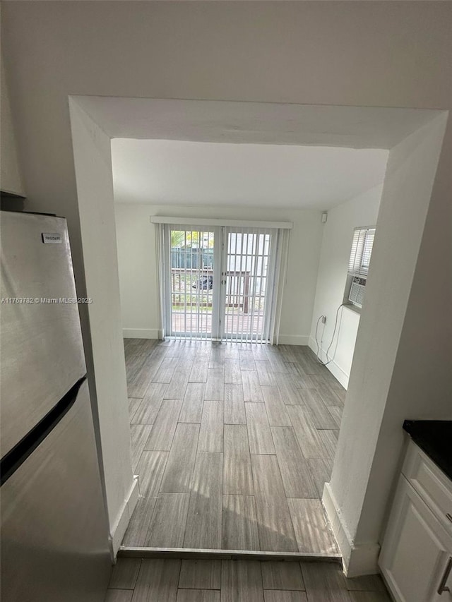 interior space with baseboards and wood tiled floor