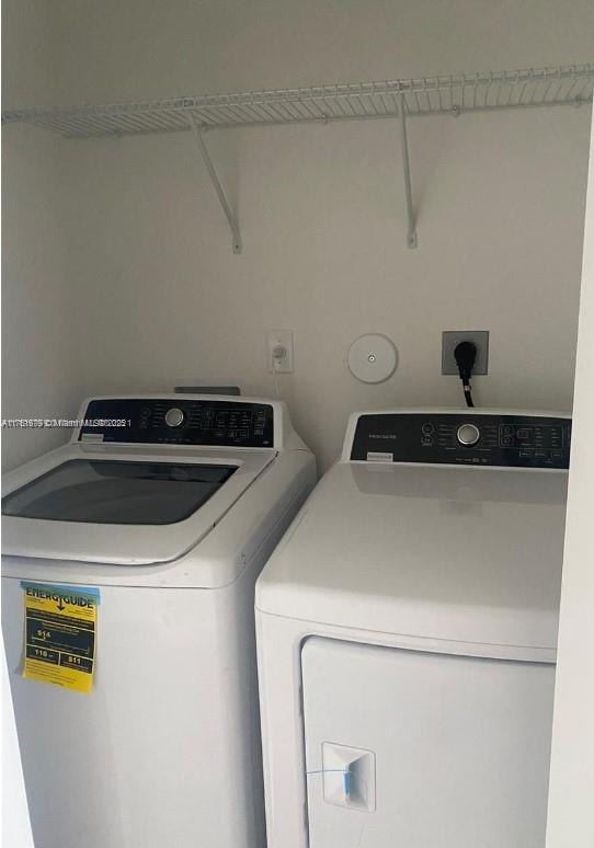 laundry area with washing machine and dryer and laundry area