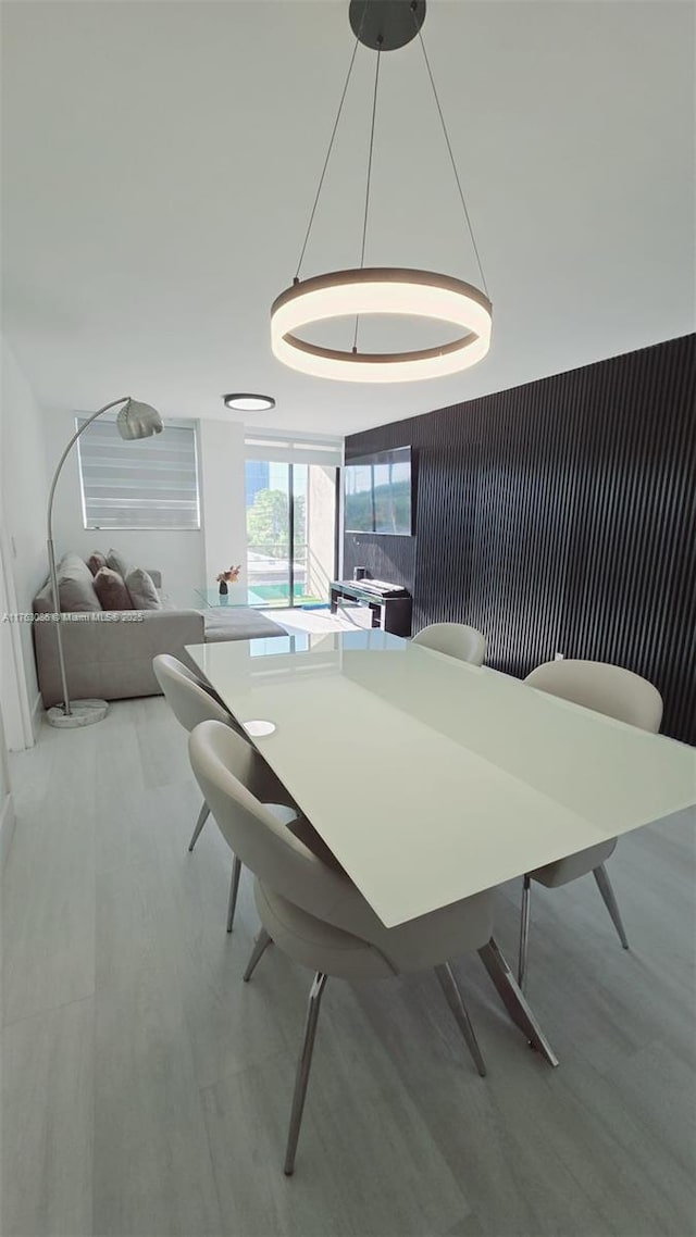 dining space with wood finished floors