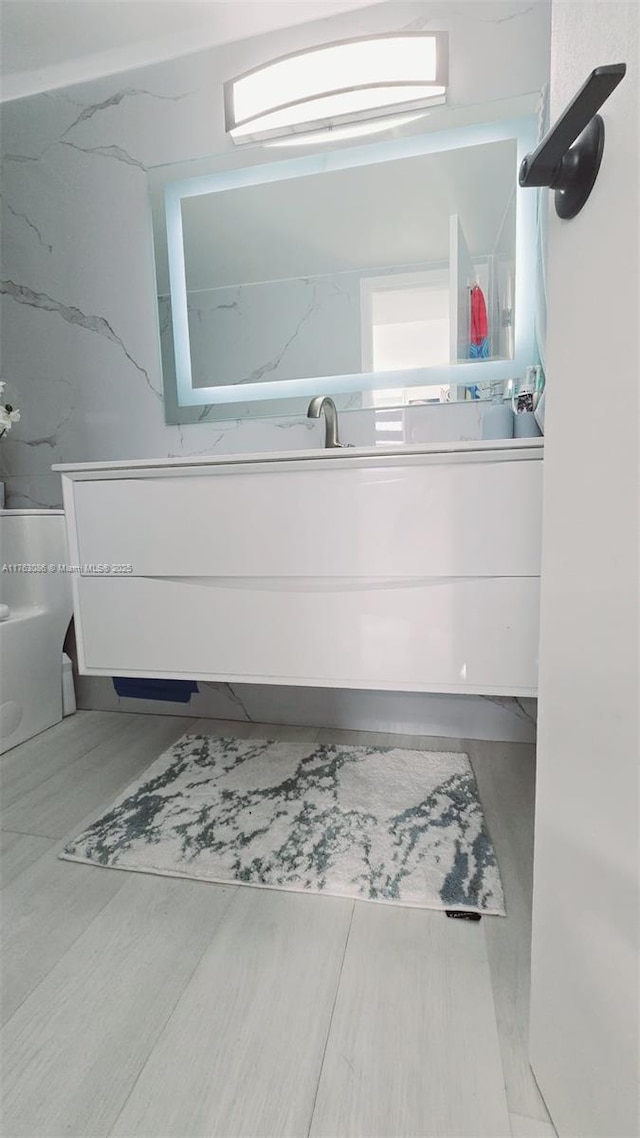 2821 N Miami Beach Blvd Unit 4F, North Miami Beach, FL 33160 - bathroom featuring vanity and wood finished floors