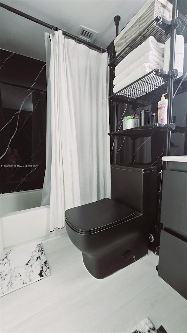 2821 N Miami Beach Blvd Unit 4F, North Miami Beach, FL 33160 - bathroom with shower / tub combo with curtain and toilet