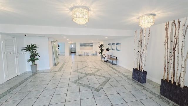 corridor with light tile patterned floors, baseboards, an inviting chandelier, and recessed lighting