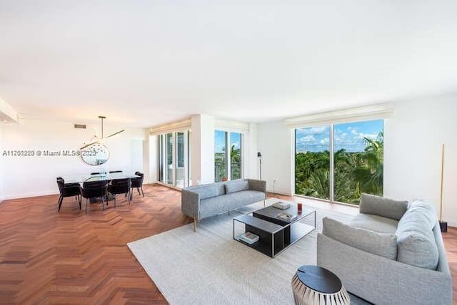 living area with visible vents and an inviting chandelier