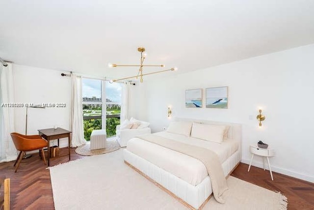 bedroom with baseboards and a chandelier