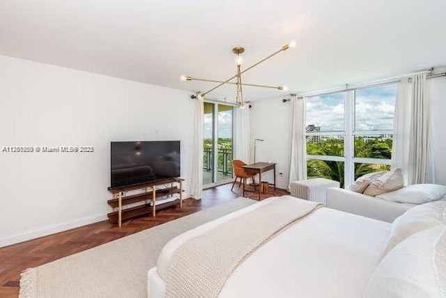 bedroom featuring access to exterior, baseboards, and a chandelier