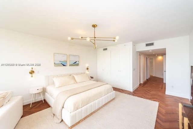 bedroom featuring a chandelier and visible vents