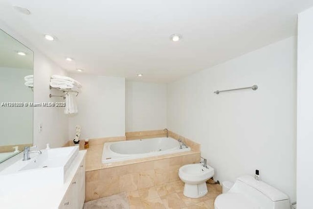 full bathroom with tile patterned floors, toilet, a bidet, a bath, and vanity