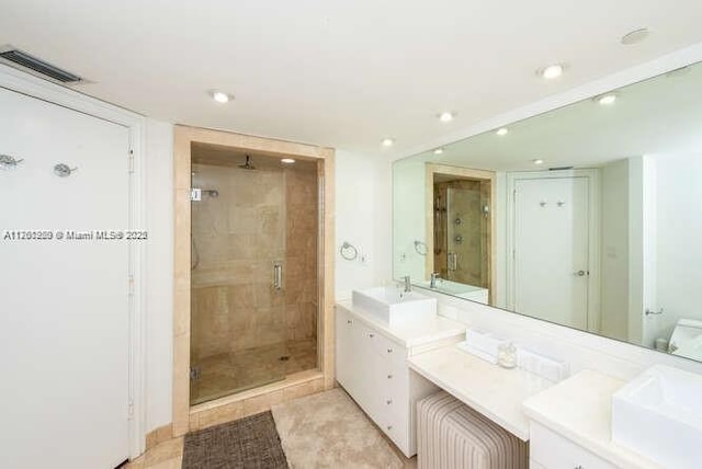 bathroom featuring recessed lighting, visible vents, a stall shower, and vanity