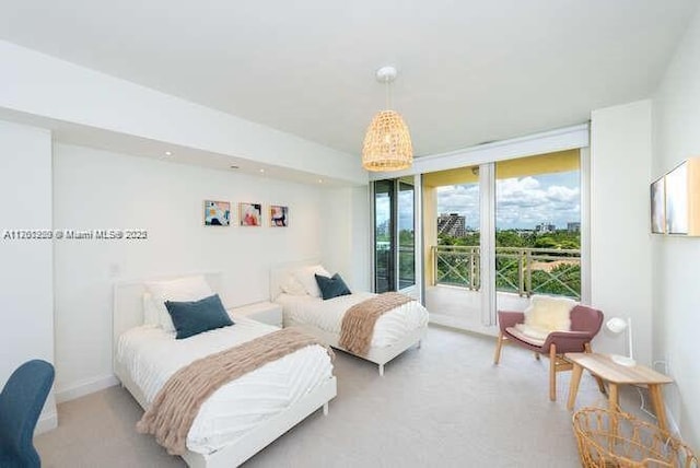 bedroom with light colored carpet and baseboards