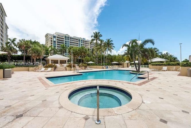 community pool featuring a patio and a community hot tub