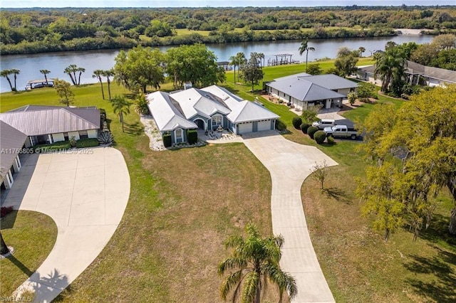 aerial view with a water view and a wooded view