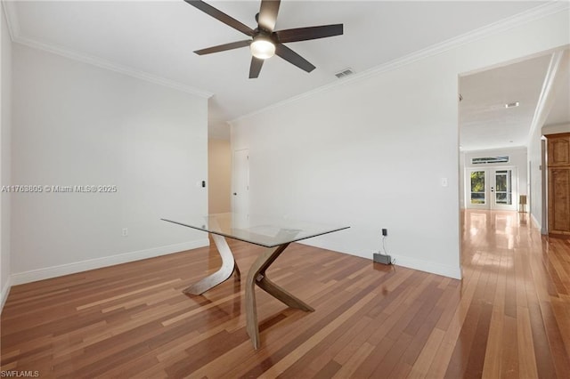 dining space with light wood finished floors, visible vents, baseboards, and a ceiling fan