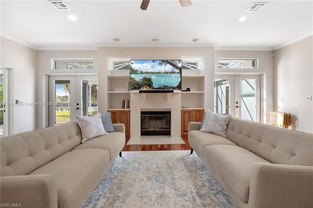 living area with a wealth of natural light, visible vents, and french doors