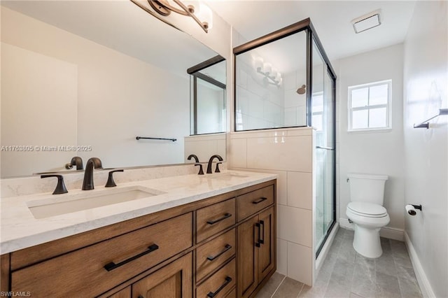 full bath with a sink, toilet, double vanity, and a shower stall