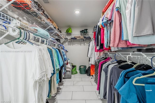 spacious closet with tile patterned floors