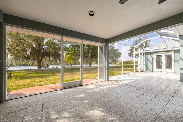 unfurnished sunroom featuring plenty of natural light and ceiling fan