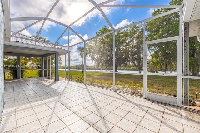 unfurnished sunroom with a water view