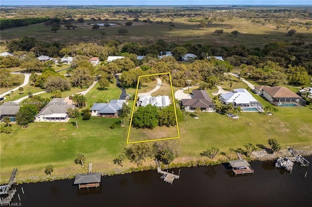 drone / aerial view with a residential view and a water view