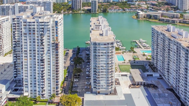 drone / aerial view featuring a view of city and a water view